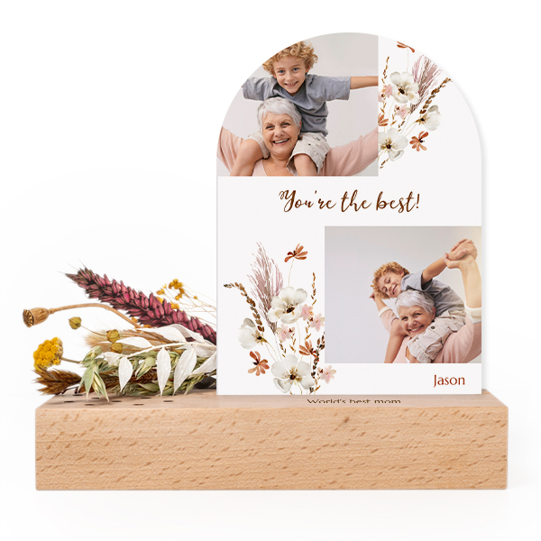 Wooden block with print, dried flowers and arched forex card