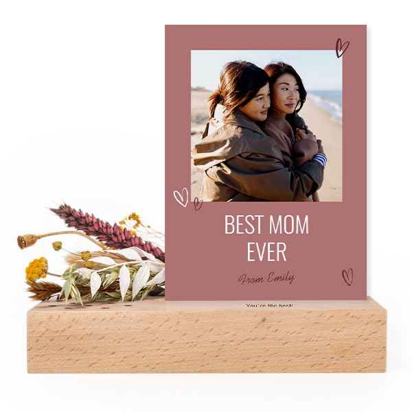Wooden block with print, dried flowers and forex card