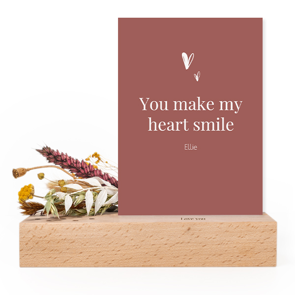 Wooden block with print, dried flowers and forex card