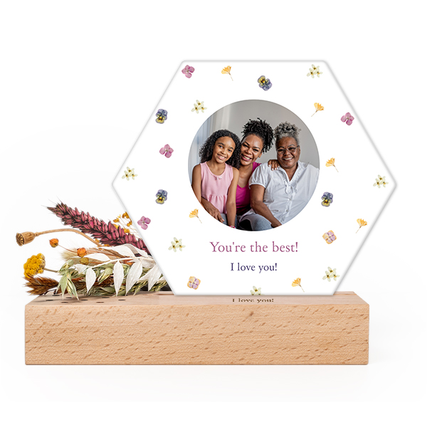 Wooden block with print, dried flowers and hexagonal forex card