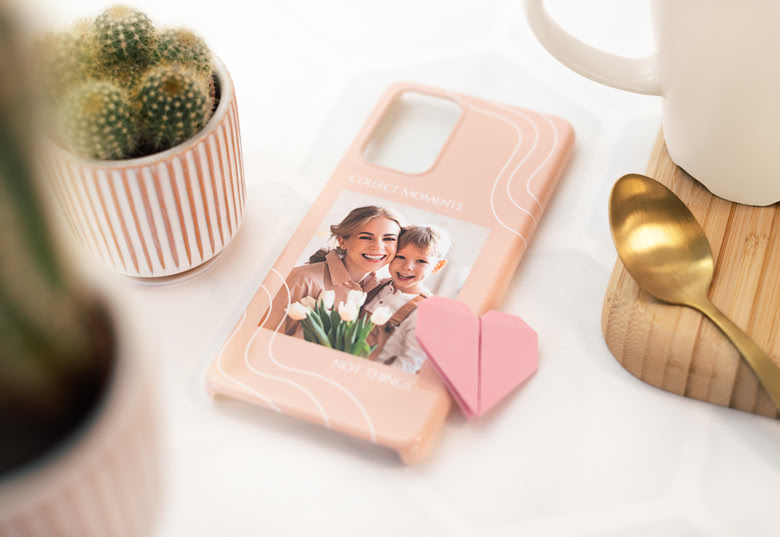 Customised peach Samsung phone case with a photo and "Collect moments, not things" text.